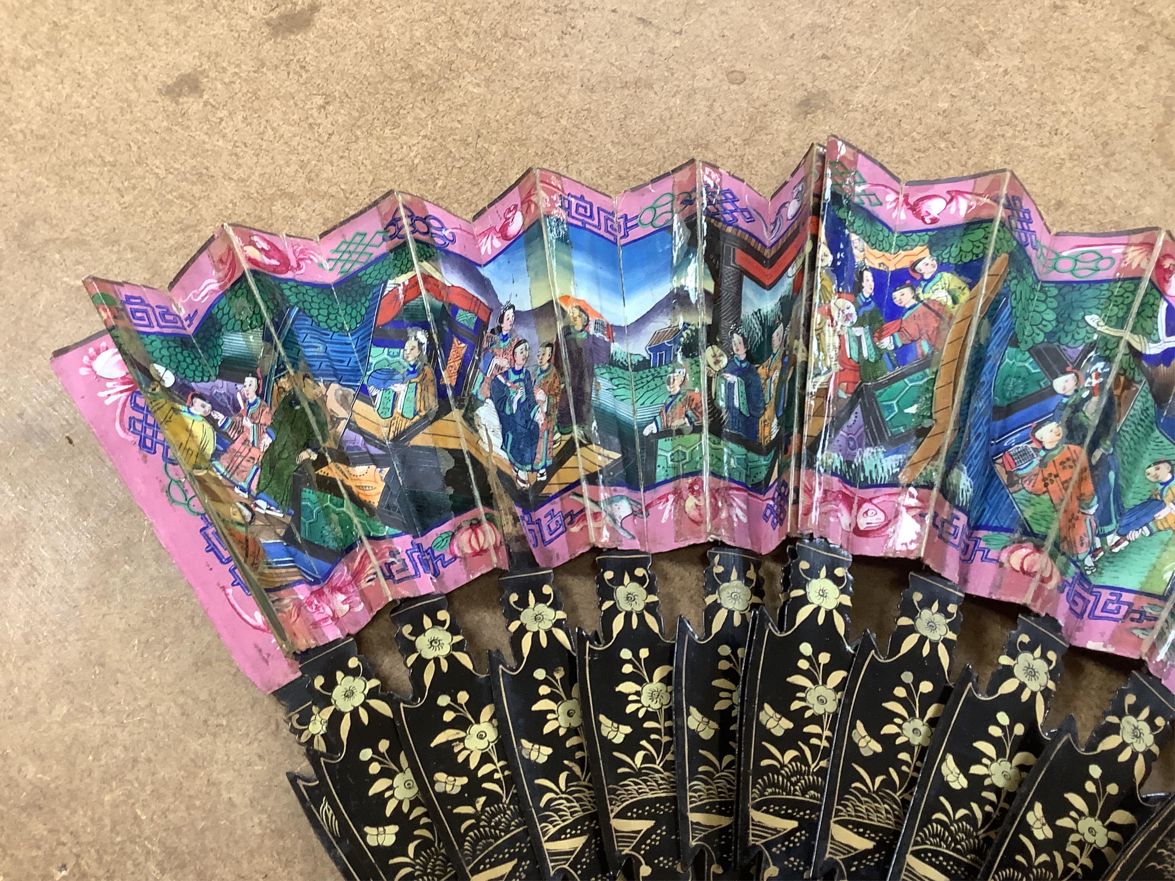 Four 19th century Chinese gilt-decorated black lacquer fans with figure painted leaves, two cased, largest 41cm